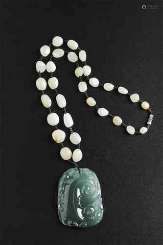 A Chinese Carved Jadeite Pendant