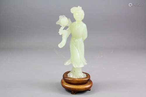 A Chinese Celadon Female Figure; the figure holding a large peony flower, approx 19 cms h