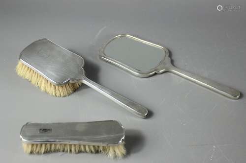 A Silver Three Piece Vanity Set; the set comprising mirror, hairbrush and clothes brush, Birmingham hallmark, mm William Greenwood & Sons Ltd, dated 1949