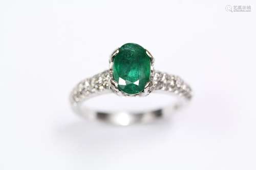 An 18ct white gold emerald and diamond ring, the ring set with an oval emerald approx 8