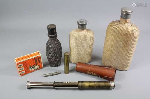 A Baden Powell Teliscout telescope, nr 315245, in the original case, brass powder flask nr 547, silver calendar and match holder together with three antique drinking flasks