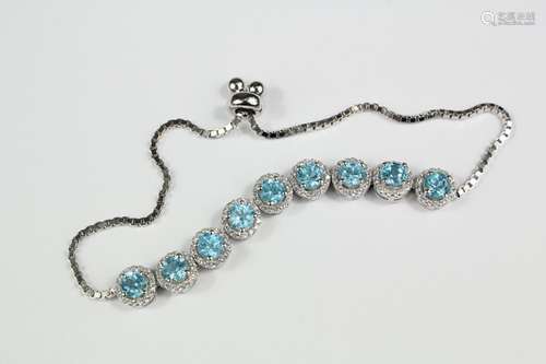 Silver and Aquamarine bracelet, set with nine stones of approx 5mm each, approx 10