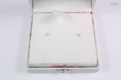 Diamond ear studs, contained in glossy white box