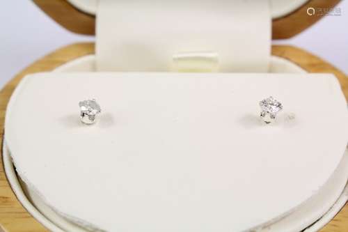 A pair of diamond earring studs, with 18ct wings and silver posts and setting, approx 0