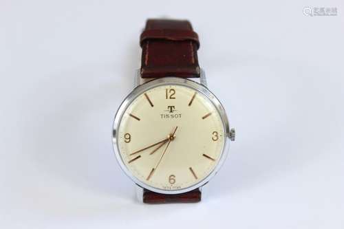 A Tissot Gentleman's Wrist Watch; the watch having a champagne face with numeric and baton dial, on brown leather strap