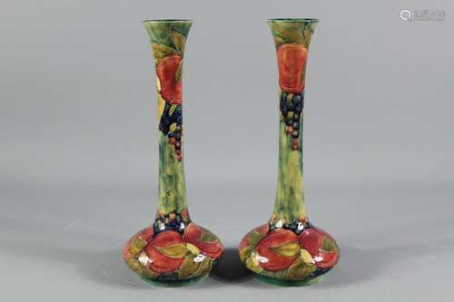 Early 20th Century William Moorcroft vases; the pair of vases depicting pomegranate pattern, signed in green by William Moorcroft dated 1913