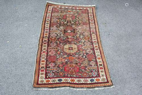 An Old Russian Carpet in Autumnal shades; approx 210 x 120 cms, selvedges and tassels worn but complete