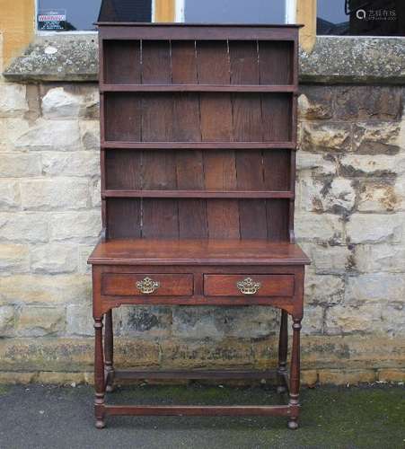 An oak cottage dresser; the dresser having two drawers, turned legs, straight stretchers, three shelves above, approx 112 x 182 x 50 cms