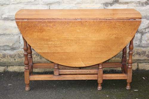 Light Oak Drop Leaf Table, approx 122 x 130 x  76 cms, the table having turned legs, straight stretchers bun feet, together with Heals dining chairs, including two carvers and two dining chairs, with factory label to base