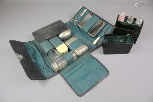 Gentleman's grooming set, comprising soap dish, razor, clothes brush, two cut-glass jars, mirror and nail implements together with a green leather box containing three bottles