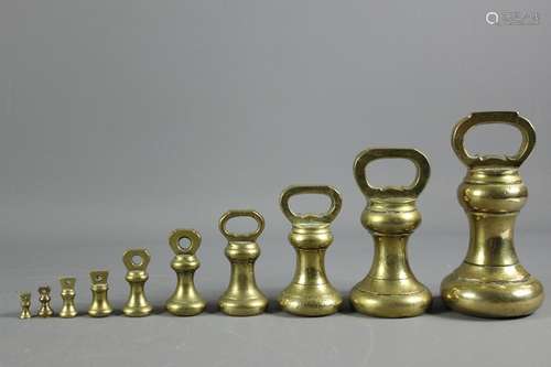 A Set of Victorian brass graduated scale weights, the largest weighs 7 pounds the smallest 1/4 ounce