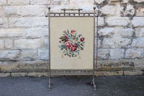 A Vintage Brass Firescreen/Guard; the tapestry depicting a floral bouquet, initials AL 1974 to lower left and JT lower right,decorative base on bow legs, approx 58 x 99 cms