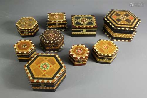 Nine marquetry boxes; the boxes intricately patterned, in various shapes and sizes, one stamped 