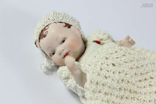 A Victorian miniature bisque headed infant doll; the doll marked PD80 to back, with delicately painted features, approx 10 cms