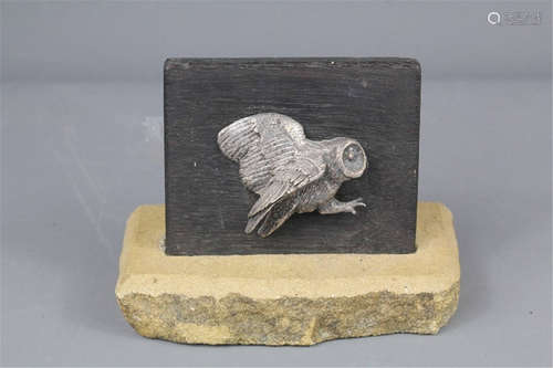 A silver owl, mounted on an oak plinth and supported on a piece of Cotswold stone, approx 9 x 7 cms (does not include the stone), modelled by John Brooks of Winchcombe