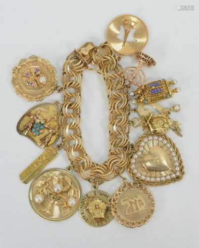 14 Karat Gold Charm Bracelet with 14 karat gold charms.