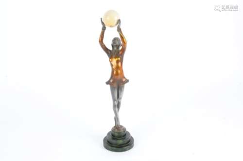 An Art Deco style dancer with arms upstretched raising a ball, upon a green base, height 41cm figure