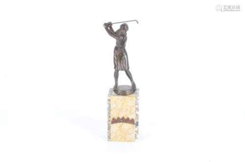 A spelter figure of a golfer, raised on an oblong stone plinth, height 36cm