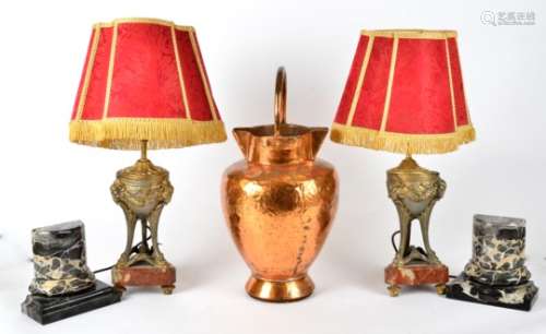 A pair of 19th Century metalwork rams head vessels later converted to lamps, raised upon marble
