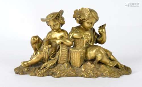 A bronze figure of children, seated upon a mossy bank, each with a basket filled with a plentiful