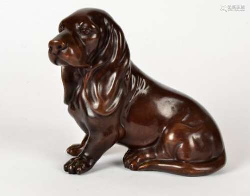 A contemporary bronze sculpture of a seated dachshund, 18cm x 20cm