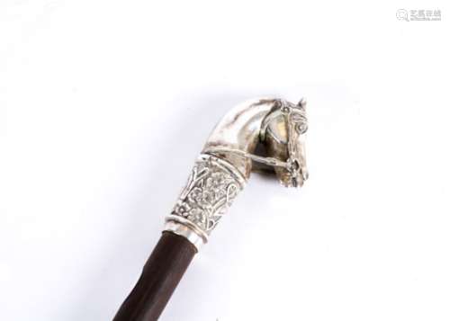 A walking stick topped with a silver study of a horses head, marked 800, length 85cm