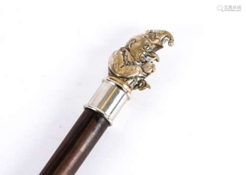 A walking stick topped with a plated figure of Mr Punch, the notorious villain from Punch and