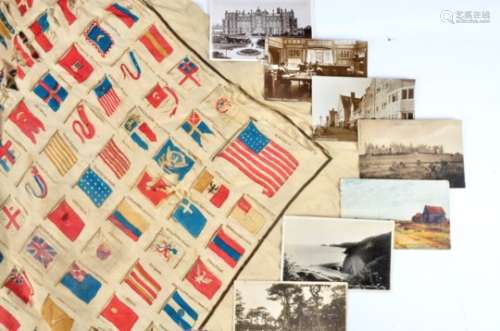 An antique scarf decorated with the flags of nation states, together with a collection of postcards,