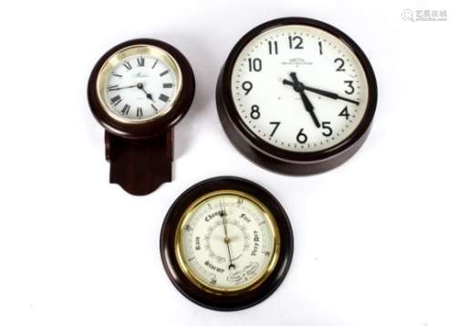 A Bakelite electric clock by Smiths, circular dial with Roman numerals and a plastic cover (