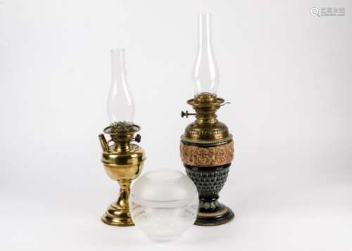 A late Victorian or Edwardian oil lamp, with a ceramic base with decorations of female Sphinx hybrid