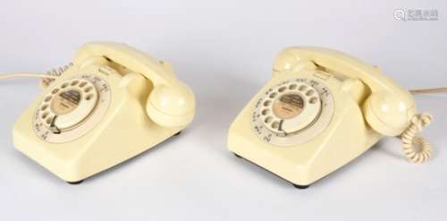 Two white vintage telephones, both with rotary dials