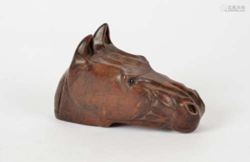 A 19th Century carved horses head table snuff, with inset glass eyes and charismatic face, length