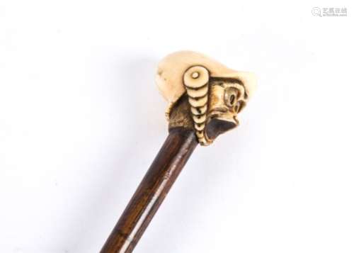 A 19th Century ivory topped walking stick, topped with an expressive monkey's head, he is wearing