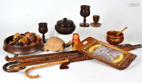A collection of treen, including four walking canes, a bamboo handled umbrella, various hardwood