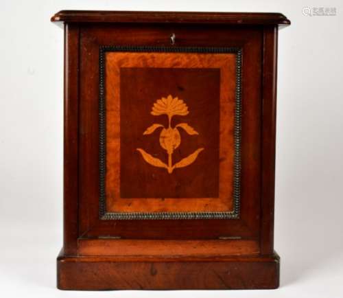 An inlaid cabinet with a floral motif, opening to reveal three small drawers, and a lower shelf,