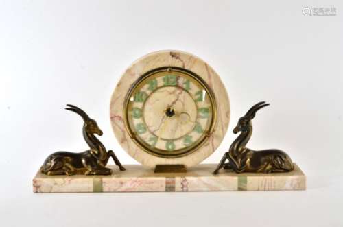A French Art Deco circular clock, the sides framed with cast metal gazelles, raised on a coloured
