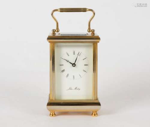 A brass carriage clock, raised on four feet, with makers name 'John Morley', height 15cm