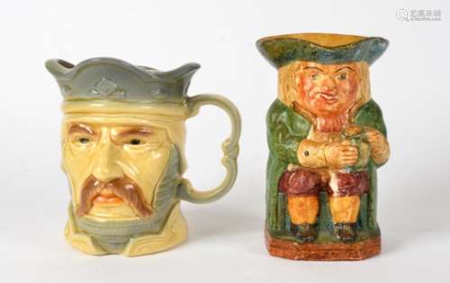A Compton pottery toby jug, the figures of Toby holding a jug of ale and the base having an