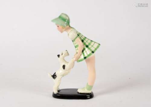 A Goldscheider Art Deco figure of a young girl playing with dog, raised on a black oval base,