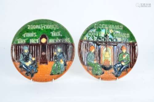 A pair of Dutch pottery plates, lead glazed earthenware with domestic interior scenes, diameter 26cm