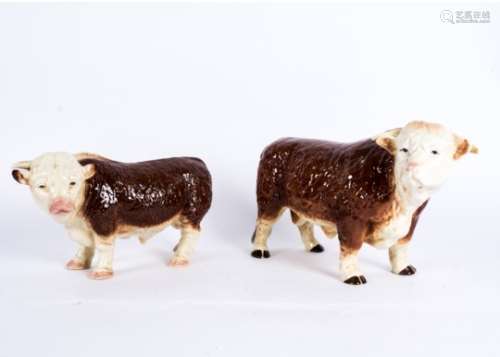 Two Melba ware figures of Hereford bulls, length 35cm & 42cm (2) one with a broken horn, both with