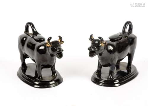 A pair of Victorian era Jackfield of Shropshire Cow creamers, both with original stoppers, black
