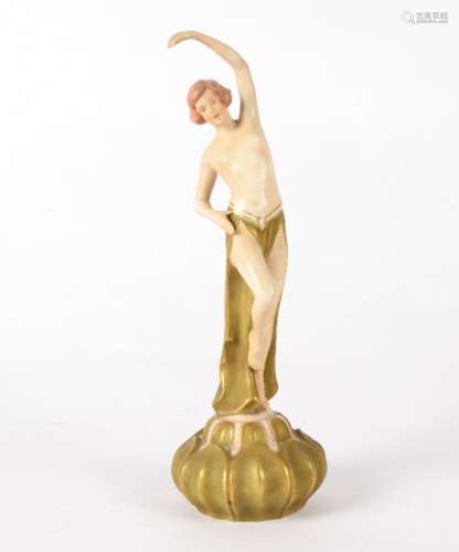 A Royal Dux figure of a dancer, with one arm upstretched, the other against her hip, one leg
