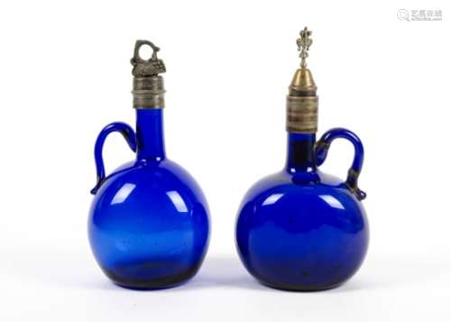 A pair of antique hand-blown Bristol blue claret jugs, each of squat globular form, pontil marks
