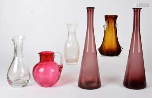 A pair of amethyst glass bottle vases, a cut glass water carafe, a cranberry glass jug and two other