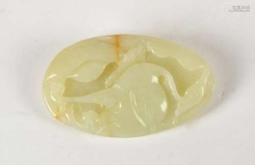A 19th Century Chinese jade carving, oval shaped, with a carving of a stork to one side, in