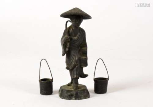 A Chinese bronze figure, taking the form of a figure with a conical hat and implement, together with