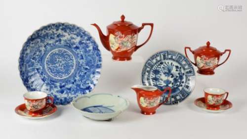 A Chinese 20th Century tea set, upon a red ground with cartouches of a female deity amidst clouds,