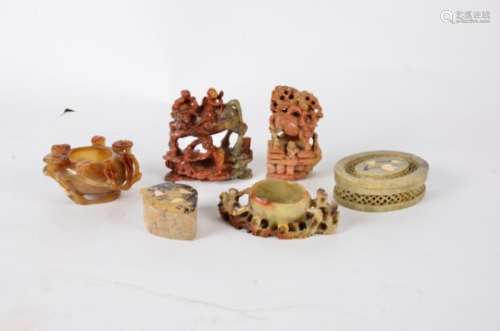 A small collection of Chinese agate and soapstone sculptures, including a small vessel surrounded by