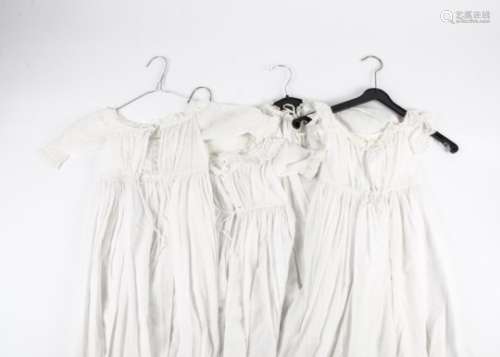 A quantity of Victorian and later christening gowns, decorated with lacework, whitework and